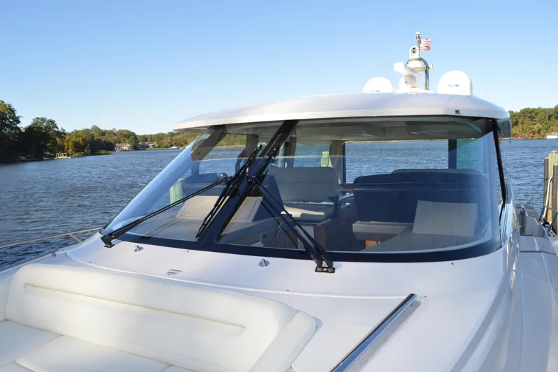 Slide: The Image of 2024 Tiara Yachts EX 60 on serene water, showcasing sleek design and modern features. - 12