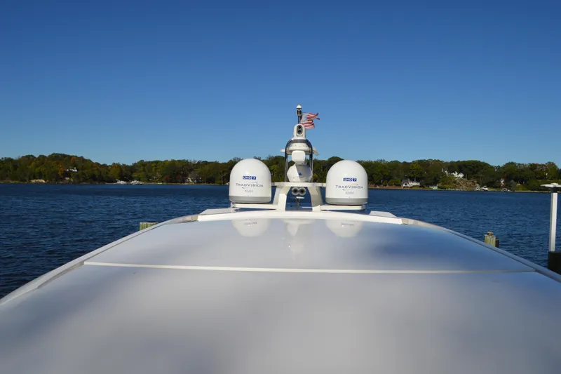 Slide: The Image of 2024 Tiara Yachts EX 60 on water, featuring radar domes and clear blue sky. - 13