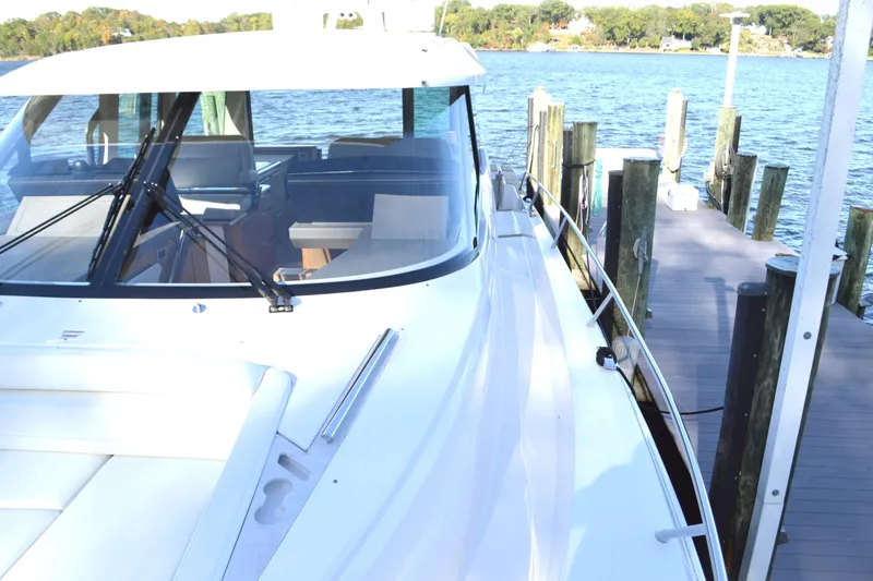 Slide: The Image of 2024 Tiara Yachts EX 60 docked, showcasing sleek design and luxurious features. - 16