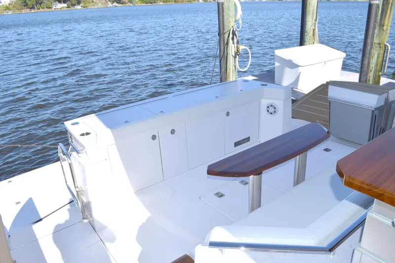 Slide: The Image of 2024 Tiara Yachts EX 60 deck with seating and water view. - 18