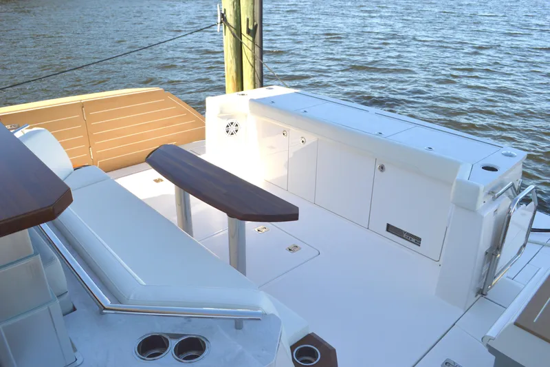 Slide: The Image of 2024 Tiara Yachts EX 60 deck with seating and storage, overlooking water. - 19