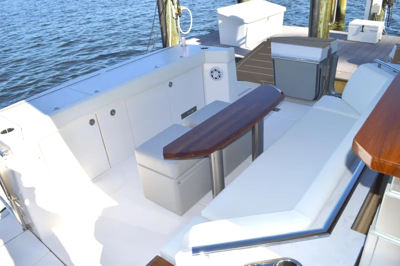 Slide: The Image of Luxurious seating area on 2024 Tiara Yachts EX 60, docked by the water. - 22