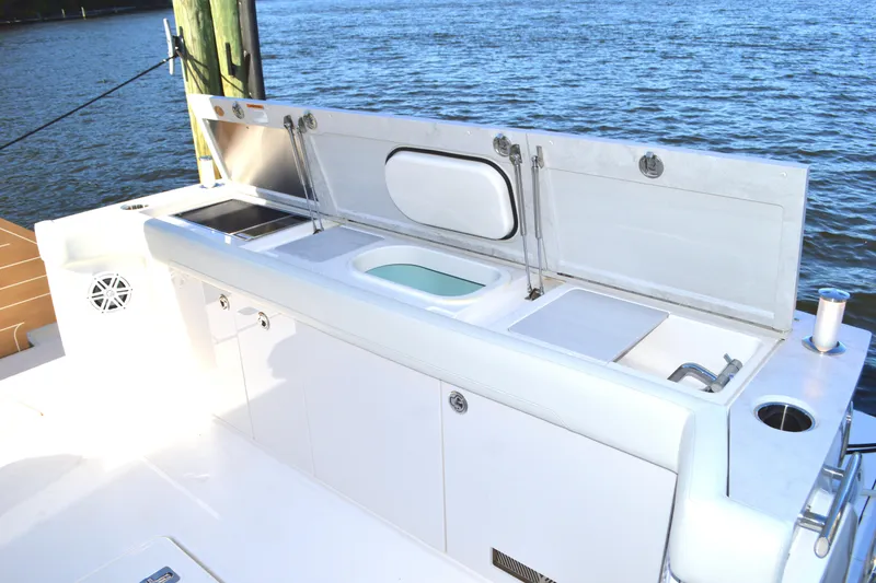 Slide: The Image of Outdoor kitchen on 2024 Tiara Yachts EX 60, featuring sink and storage, by the water. - 24