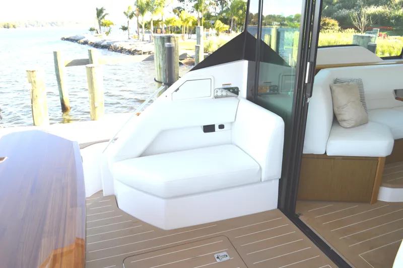 Slide: The Image of Luxurious seating area on 2024 Tiara Yachts EX 60, featuring elegant design and waterfront view. - 33