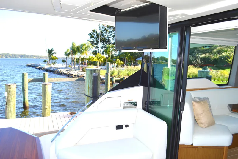 Slide: The Image of 2024 Tiara Yachts EX 60 interior with waterfront view and modern amenities. - 34