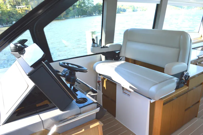 Slide: The Image of 2024 Tiara Yachts EX 60 helm with modern controls and comfortable seating. - 39