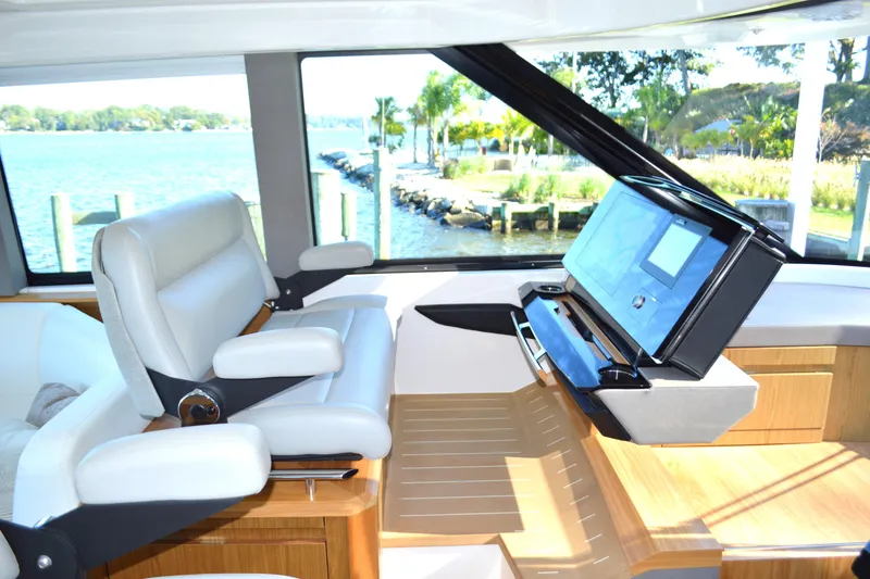 Slide: The Image of 2024 Tiara Yachts EX 60 helm with luxurious seating and advanced navigation system. - 40