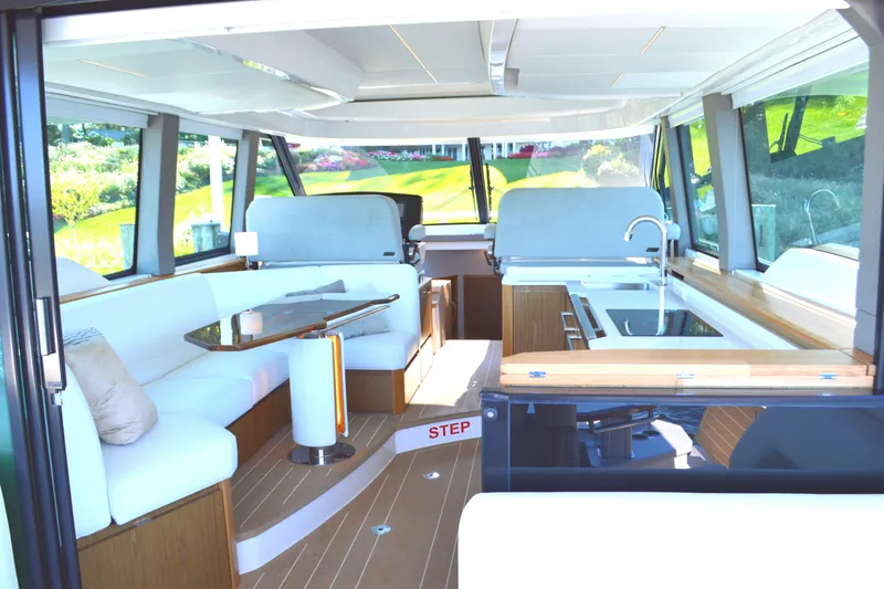 Slide: The Image of Luxurious interior of 2024 Tiara Yachts EX 60, featuring modern seating and sleek kitchen area. - 44