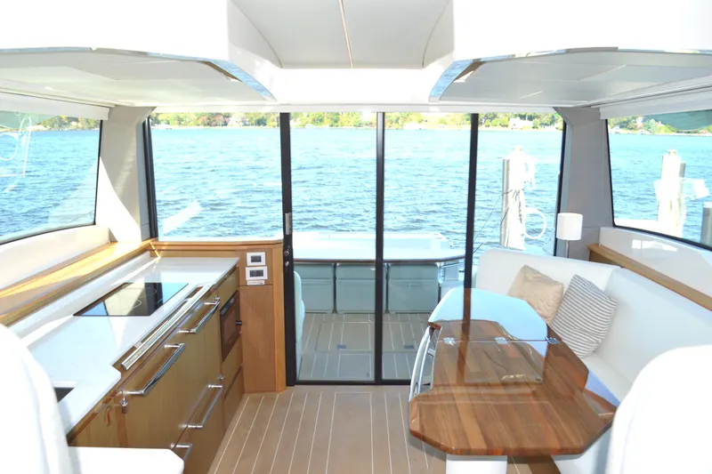 Slide: The Image of Luxurious interior of 2024 Tiara Yachts EX 60 with elegant wood finishes and lake view. - 45