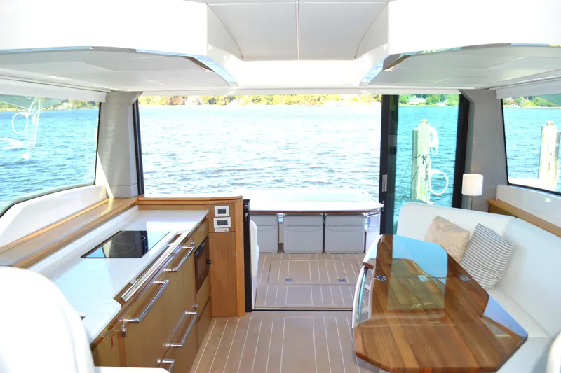 Slide: The Image of Luxurious interior of 2024 Tiara Yachts EX 60 with modern kitchen and scenic water view. - 46