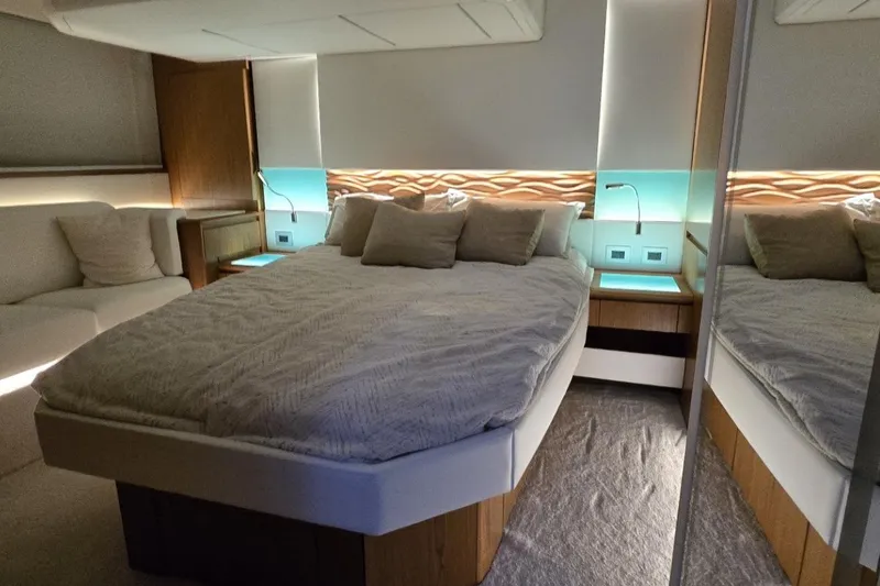 Slide: The Image of Luxurious bedroom interior of 2024 Tiara Yachts EX 60 with modern design and ambient lighting. - 58