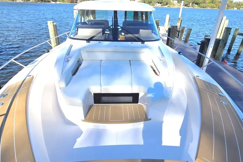 Slide: The Image of 2024 Tiara Yachts EX 60 luxury yacht docked by the water. - 6