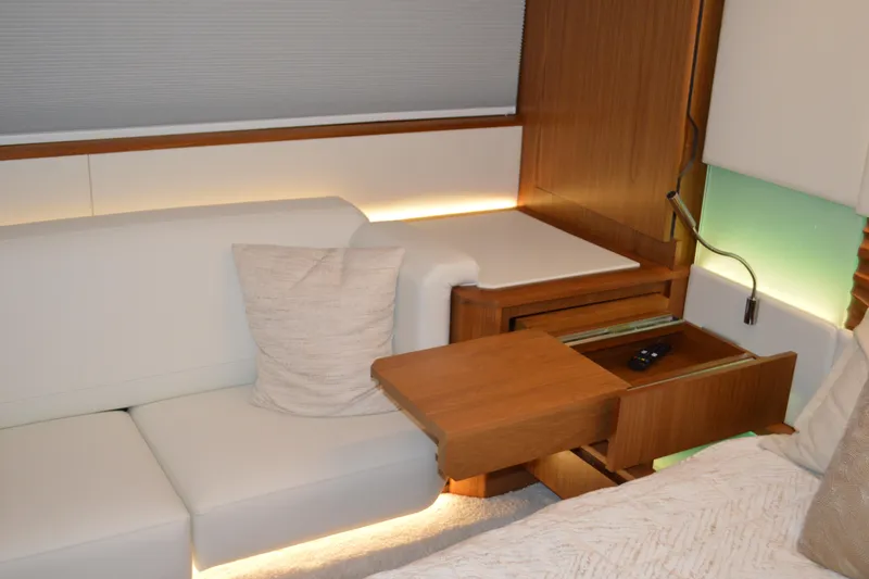Slide: The Image of Luxurious interior of 2024 Tiara Yachts EX 60 with elegant wood and white upholstery. - 63