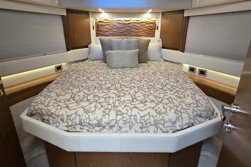 Slide: The Image of Luxurious bedroom interior of 2024 Tiara Yachts EX 60, featuring elegant bedding and wood accents. - 71