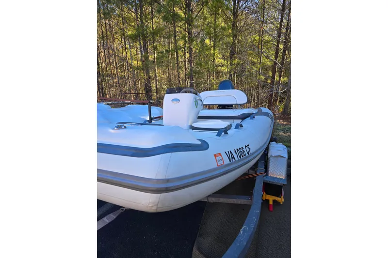 Slide: The Image of 2020 Walker Bay Generation 11 LTE boat on trailer in wooded area. - 2