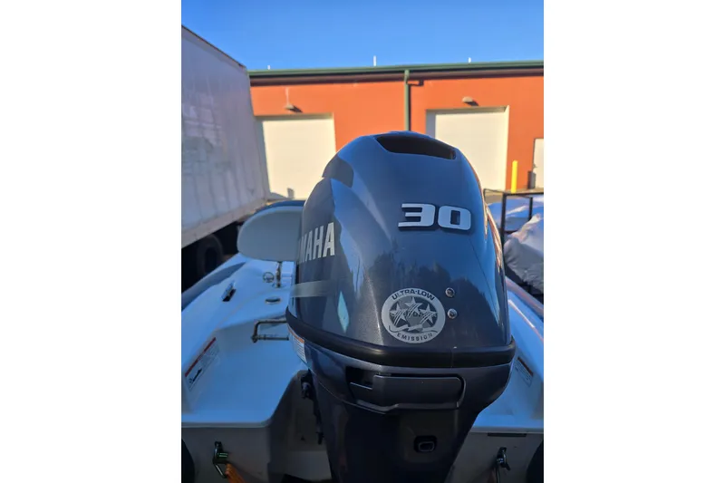 Slide: The Image of Walker Bay Generation 11 LTE 2020 with Yamaha 30 outboard motor, parked outdoors. - 4