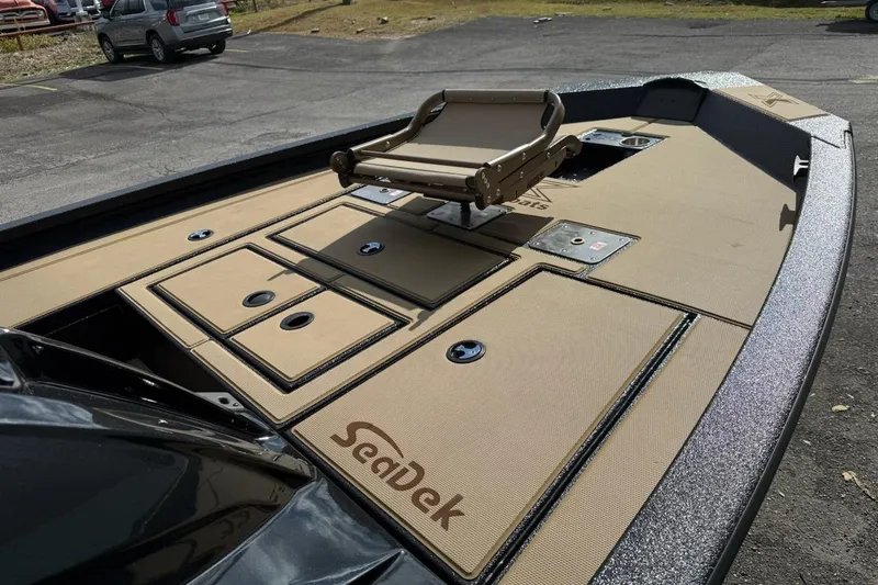 Slide: The Image of 2026 Xpress H18C Crappie boat deck with tan SeaDek flooring and fishing seat. - 3