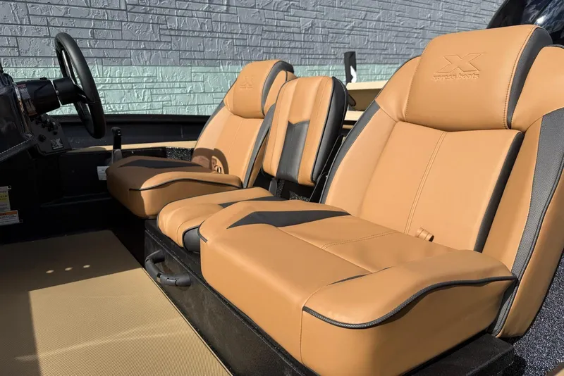 Slide: The Image of 2026 Xpress H18C Crappie boat interior with tan leather seats. - 5