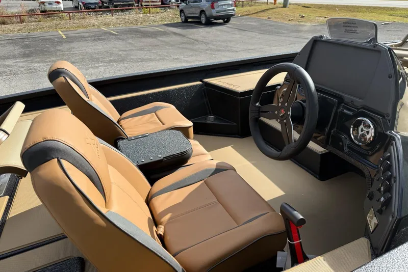 Slide: The Image of 2026 Xpress H18C Crappie boat interior with tan seats and modern dashboard. - 6