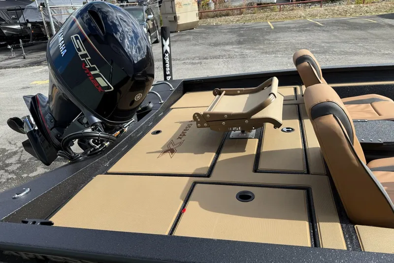 Slide: The Image of 2026 Xpress H18C Crappie boat with Yamaha engine, tan deck, and seating. - 7