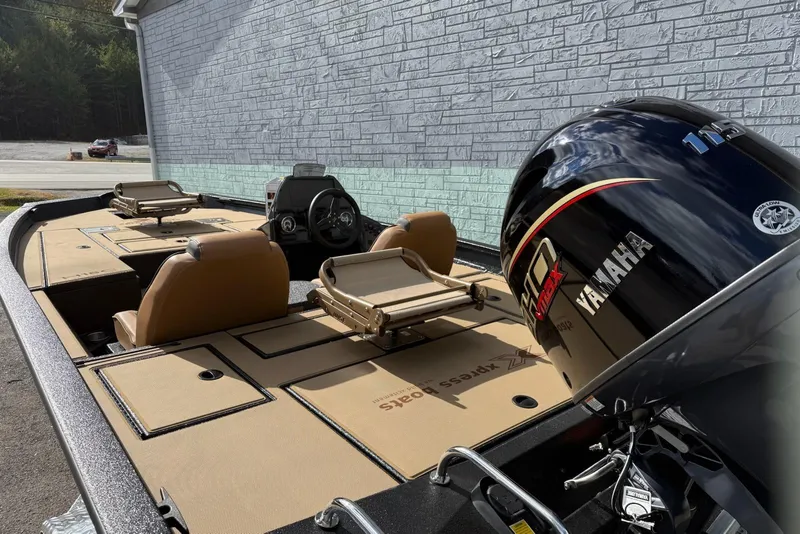 Slide: The Image of 2026 Xpress H18C Crappie boat with Yamaha engine, beige interior, and dual seating. - 8