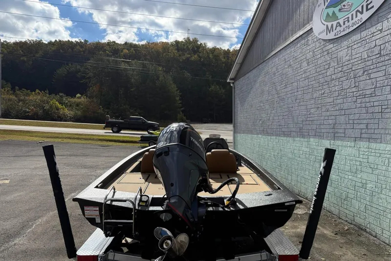 Slide: The Image of 2026 Xpress H18C Crappie boat parked outside a marine service building. - 9