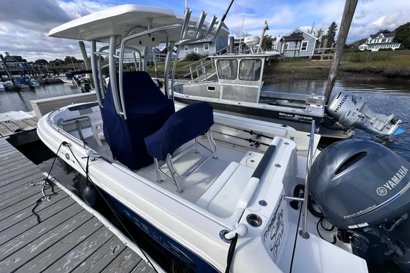 Slide: The Image of 2019 Robalo R222 Explorer boat docked with Yamaha engine, marina background. - 12