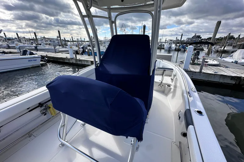 Slide: The Image of 2019 Robalo R222 Explorer boat docked at marina under cloudy sky. - 16