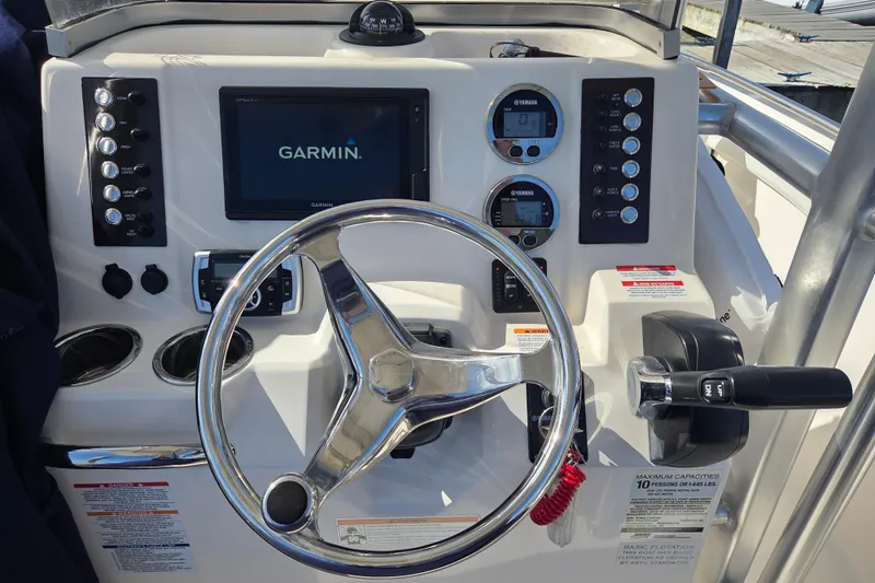 Slide: The Image of 2019 Robalo R222 Explorer boat dashboard with Garmin display and steering wheel. - 18