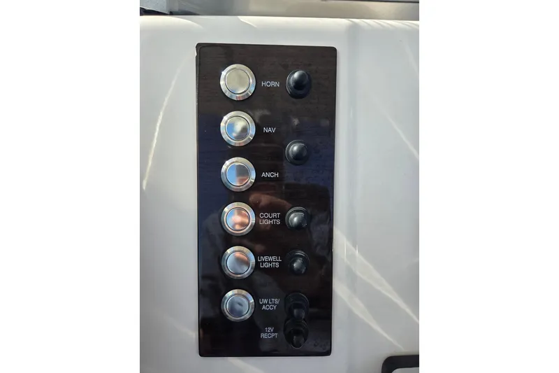 Slide: The Image of Control panel of 2019 Robalo R222 Explorer boat with labeled switches. - 20
