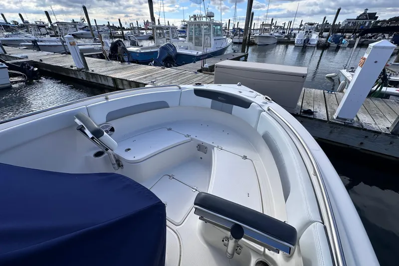 Slide: The Image of 2019 Robalo R222 Explorer boat docked at marina, showcasing spacious seating area. - 25