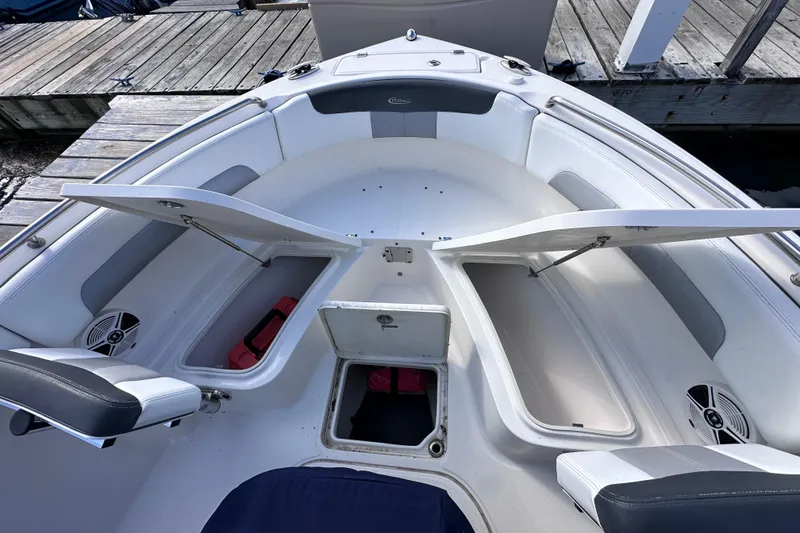 Slide: The Image of 2019 Robalo R222 Explorer boat with open storage compartments at the dock. - 26