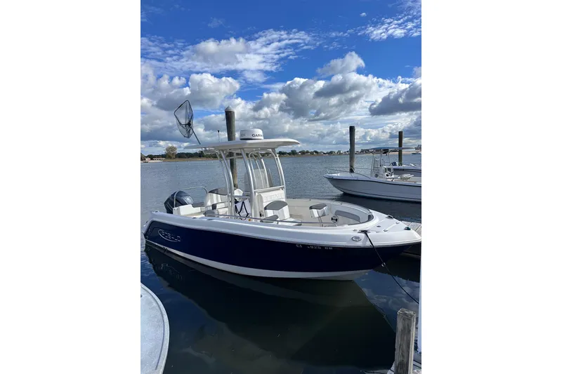 Slide: The Image of 2019 Robalo R222 Explorer boat docked on a sunny day with blue skies. - 3