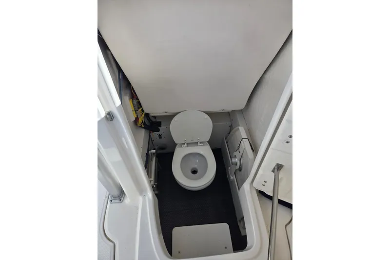 Slide: The Image of 2019 Robalo R222 Explorer boat interior with compact marine toilet. - 30