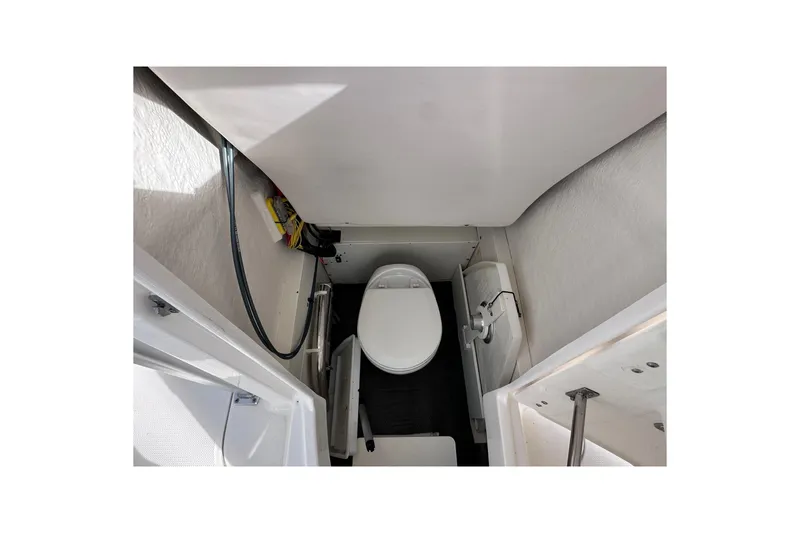 Slide: The Image of 2019 Robalo R222 Explorer boat interior with compact marine toilet. - 32