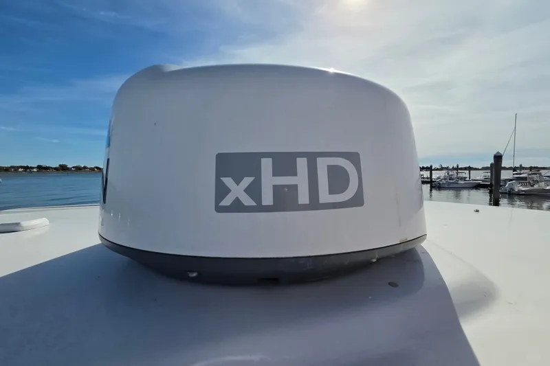 Slide: The Image of Radar dome on 2019 Robalo R222 Explorer boat, labeled xHD, with marina background. - 34