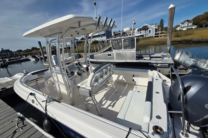 Slide: The Image of 2019 Robalo R222 Explorer boat docked at marina, featuring center console and seating. - 7