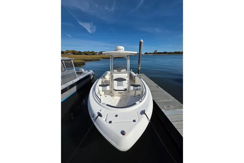 Slide: The Image of 2019 Robalo R222 Explorer boat docked on calm water under clear blue sky. - 9