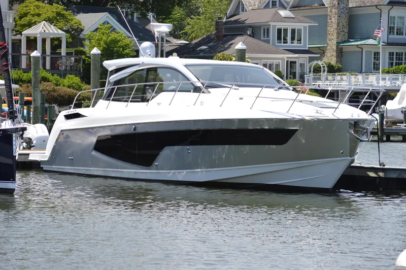 The Image of 2019 Azimut Atlantis 51 yacht docked near waterfront homes. - 4