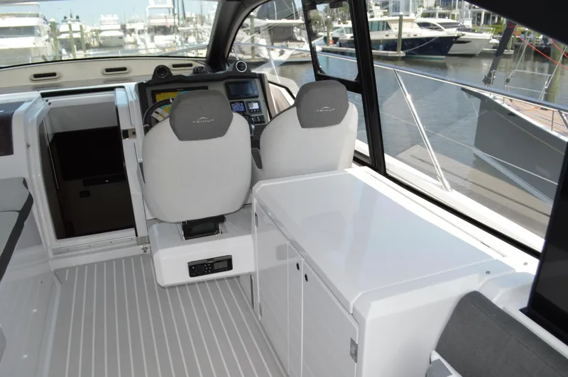 Slide: The Image of 2019 Azimut Atlantis 51 yacht cockpit with modern helm and marina view. - 40