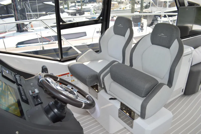 Slide: The Image of 2019 Azimut Atlantis 51 yacht cockpit with dual seats and steering wheel. - 43