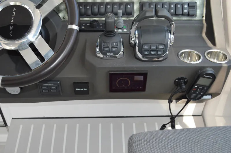 Slide: The Image of Control panel of 2019 Azimut Atlantis 51 yacht with steering wheel and navigation equipment. - 48