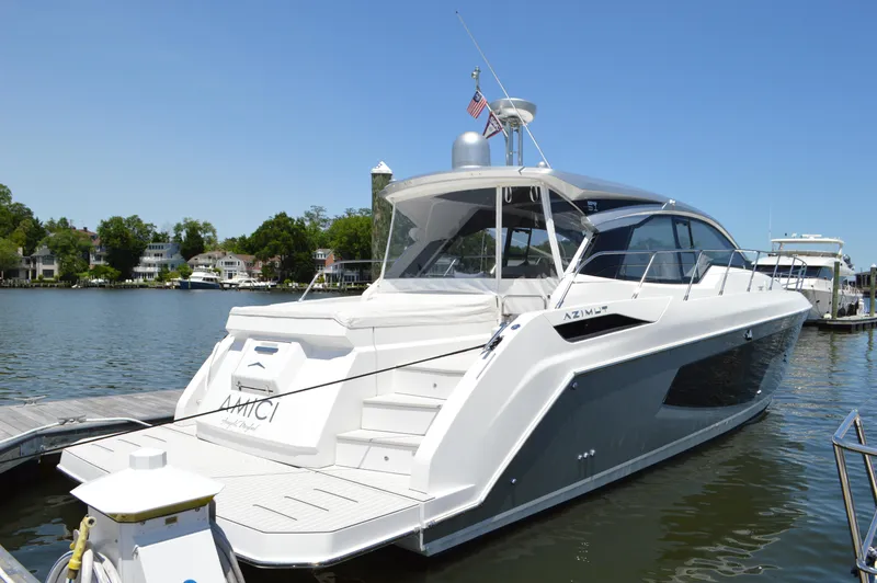 Slide: The Image of 2019 Azimut Atlantis 51 yacht docked on a sunny day, showcasing sleek design and luxury. - 7