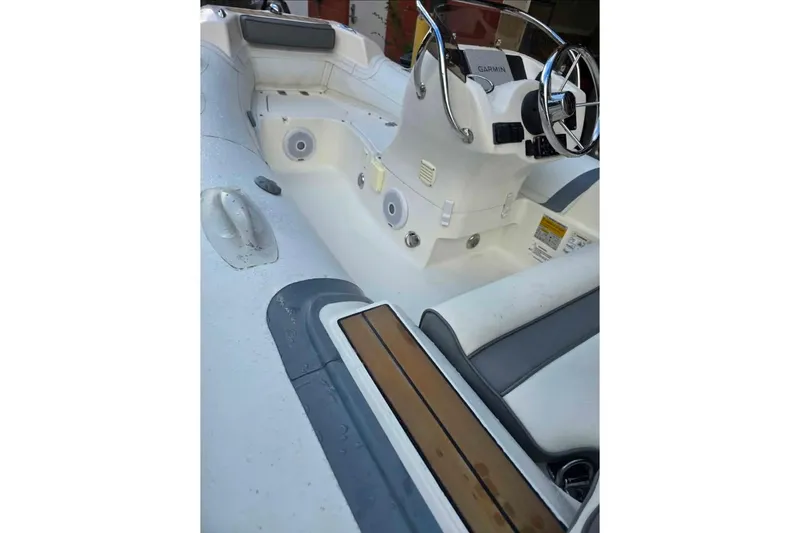 Slide: The Image of 2013 Walker Bay Generation 400 DLX boat interior with steering wheel and seating. - 5