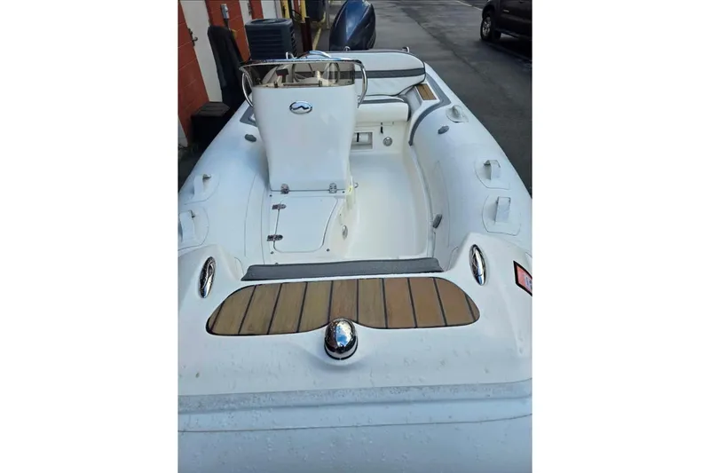 Slide: The Image of 2013 Walker Bay Generation 400 DLX inflatable boat with white interior and wood accents. - 7