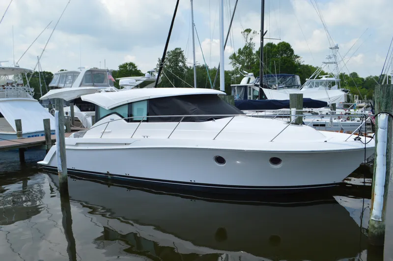 The Image of 2019 Tiara Yachts C39 Coupe docked in a marina, surrounded by other boats. - 0