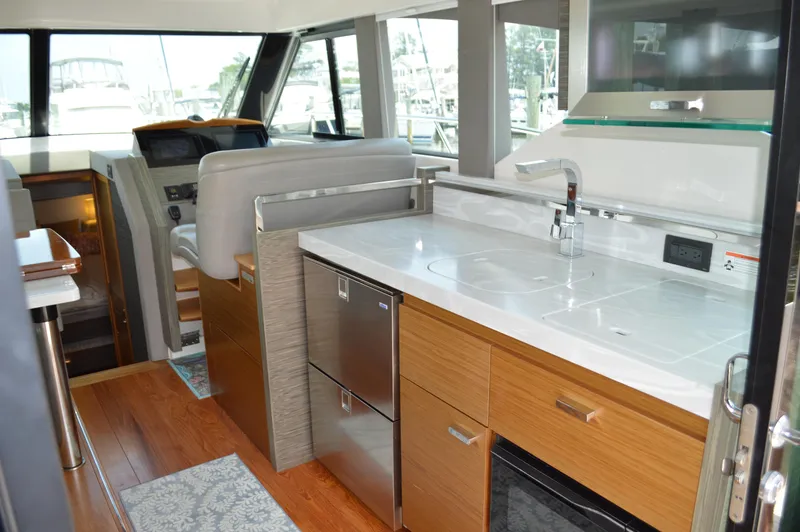 Slide: The Image of 2019 Tiara Yachts C39 Coupe interior with modern kitchen and helm station. - 32