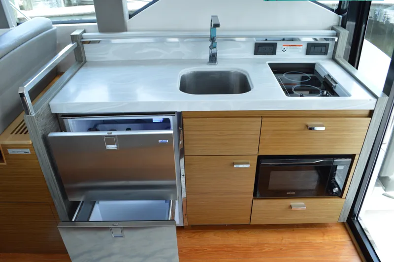 Slide: The Image of Modern yacht kitchen with sink, stove, microwave, and fridge in 2019 Tiara Yachts C39 Coupe. - 34