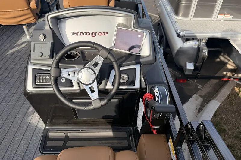 Slide: The Image of 2026 Ranger 220F boat dashboard with steering wheel and control panel. - 13