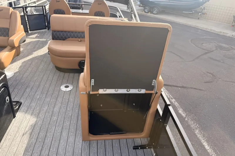 Slide: The Image of 2026 Ranger 220F boat interior with tan seating and open storage compartment. - 14